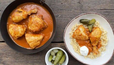 Chicken paprikas with homemade dumplings and pickles on a nice plate by Marti chef