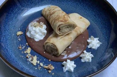 Delicious traditional Gundel Pancake on a nice blue plate