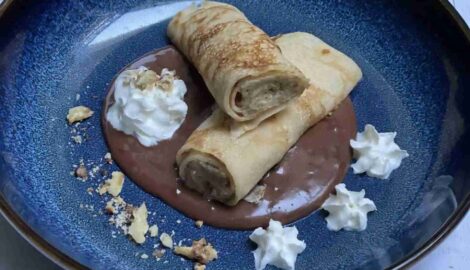 Delicious traditional Gundel Pancake on a nice blue plate