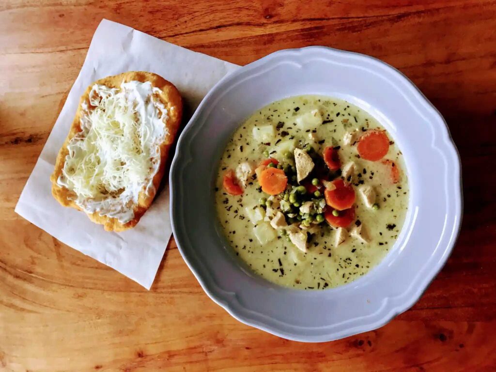 Chicken ragout soup with tarragon with Langos