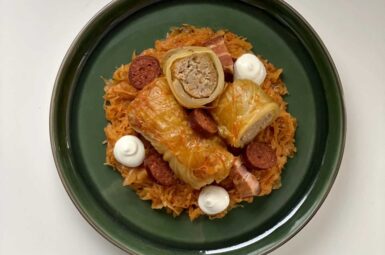 great and tasty stuffed cabbage with sour cream in a green plate