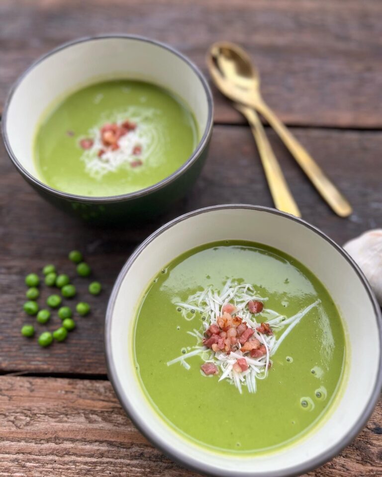 Creamy green peas soup with ground cheese on the top