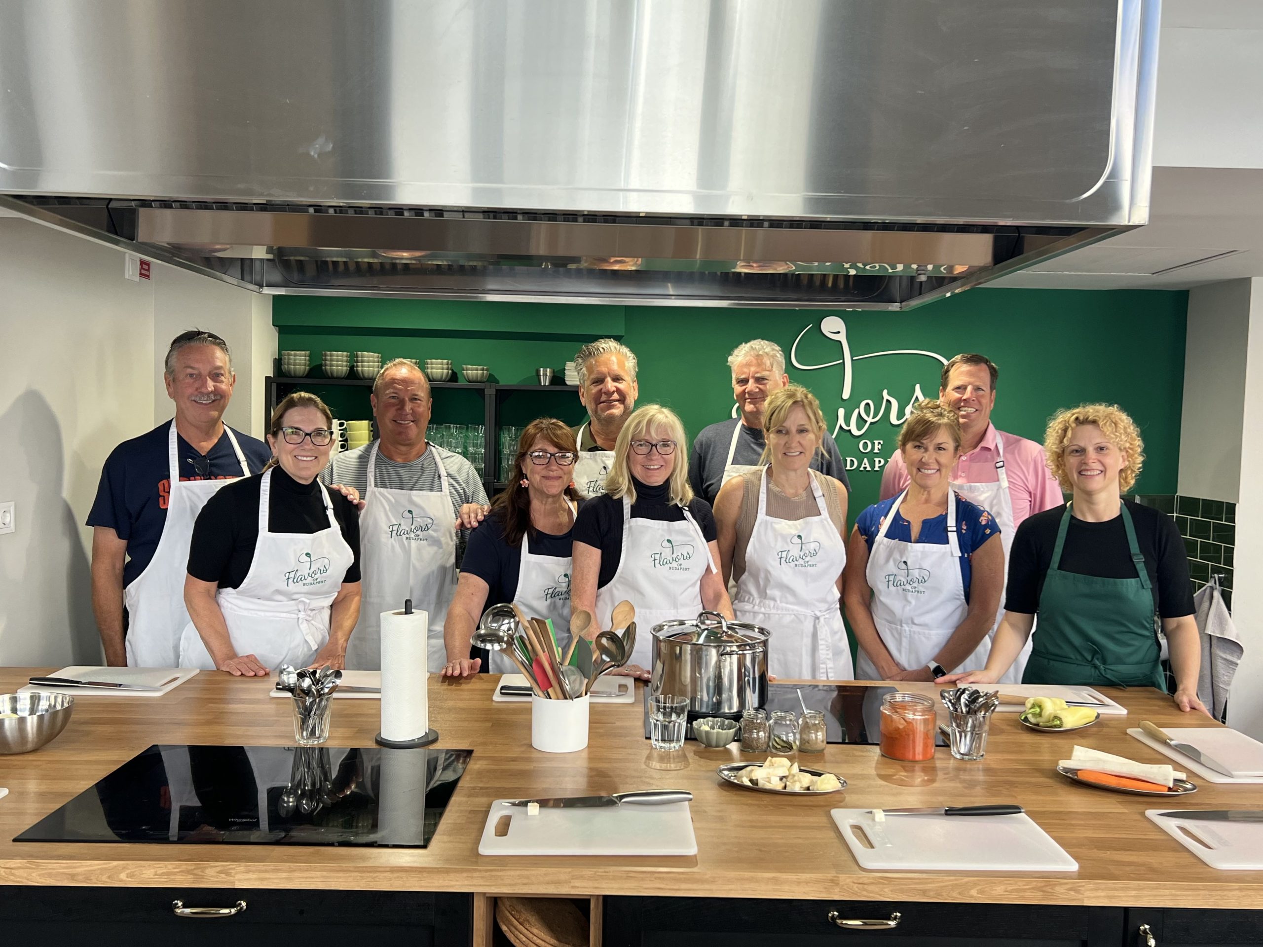 Smiling tourist group from the USA posing before their Hungarian cooking class at Flavors of Budapest Opera