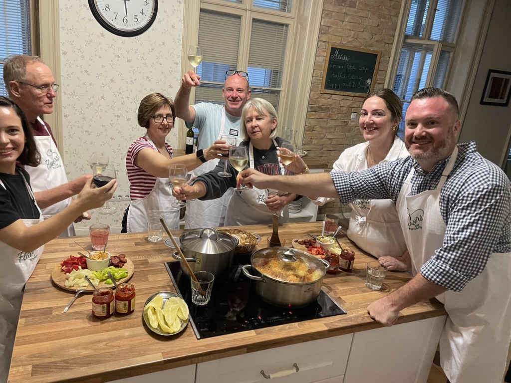 American guests enjoying a premium Hungarian cooking class at Flavors of Budapest, preparing traditional dishes in a hands-on experience