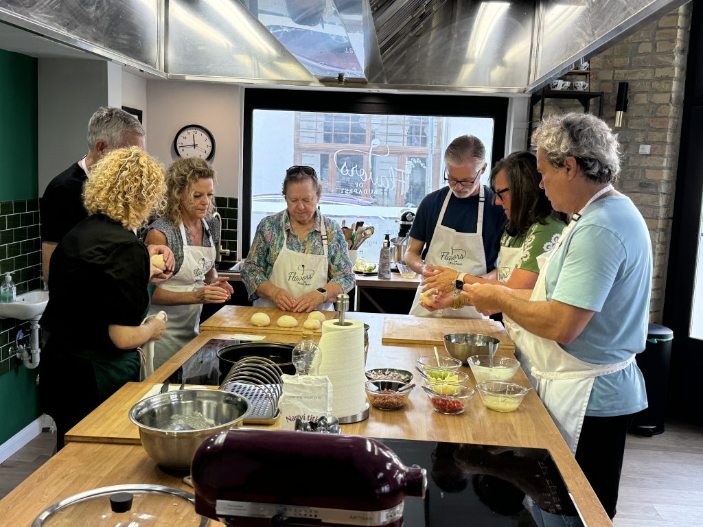 Guests shaping dough by hand during a fun and lively Hungarian Langos cooking class at Flavors of Budapest, Opera