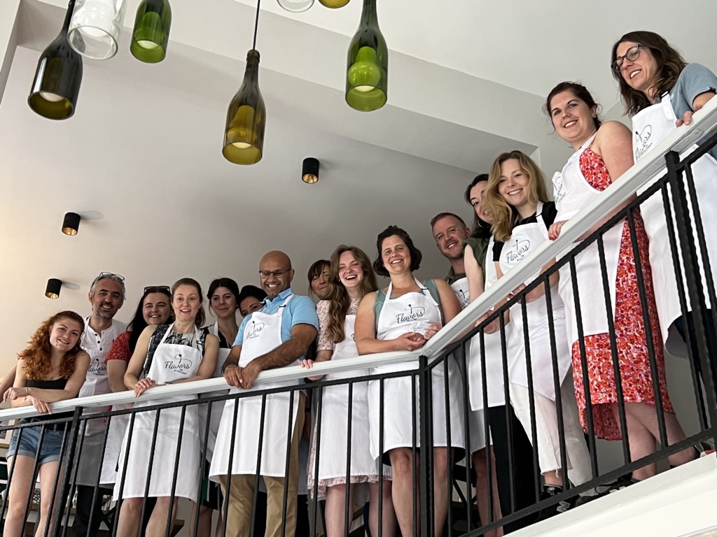 Company team gathered before their cooking team building event at the Flavors of Budapest Opera gallery