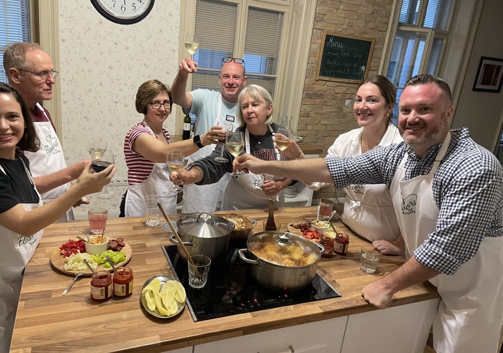 American guests enjoying a premium Hungarian cooking class at Flavors of Budapest, preparing traditional dishes in a hands-on experience